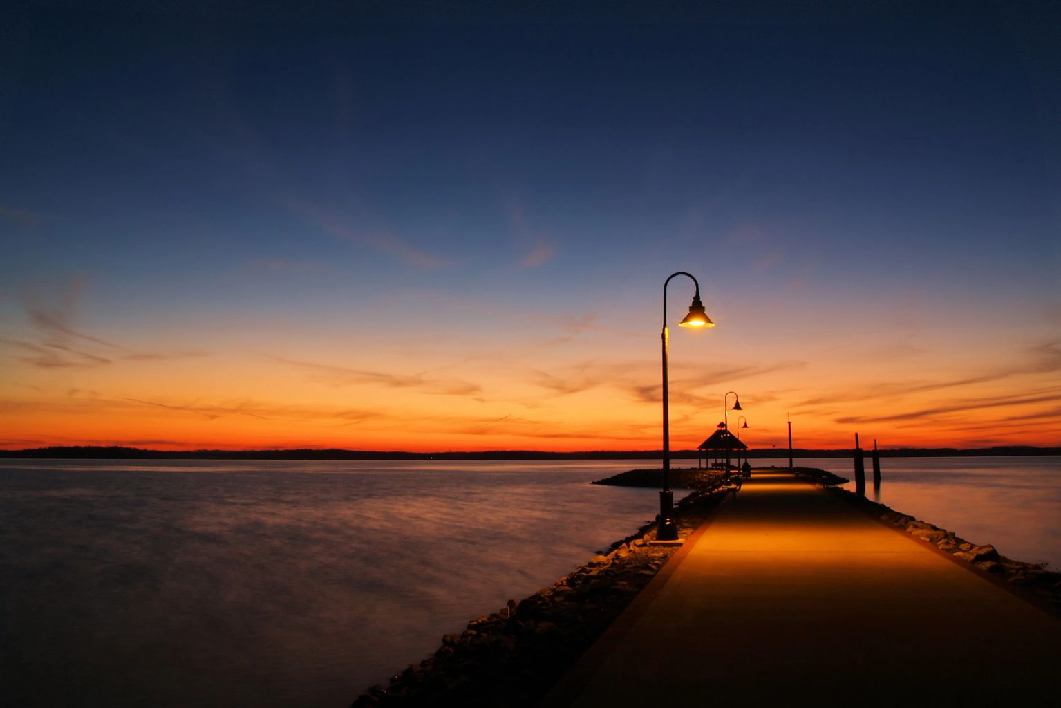 Pier and lamppost at sunset