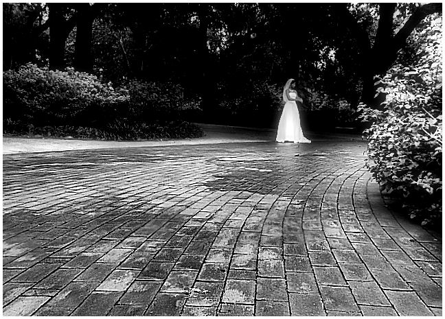 Bride standing alone in a garden